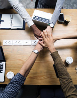 Team of business people stacking hands